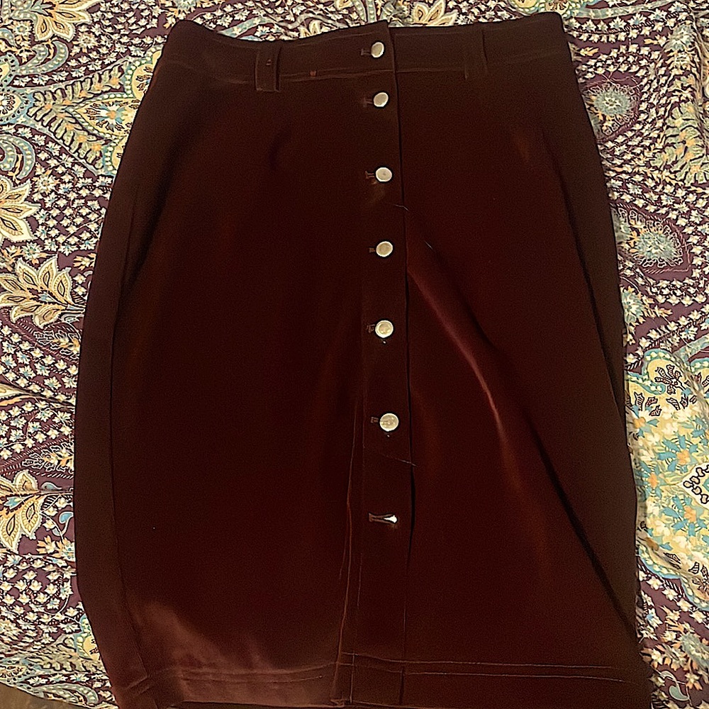 A small Button up pencil skirt in a Purple ish Maroon colour